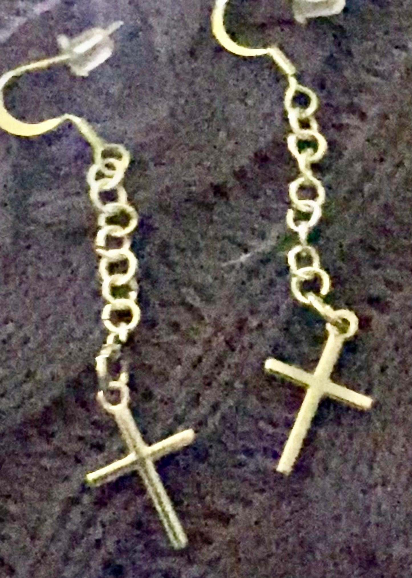Simple Silver-toned Cross earrings hanging from linked chain.