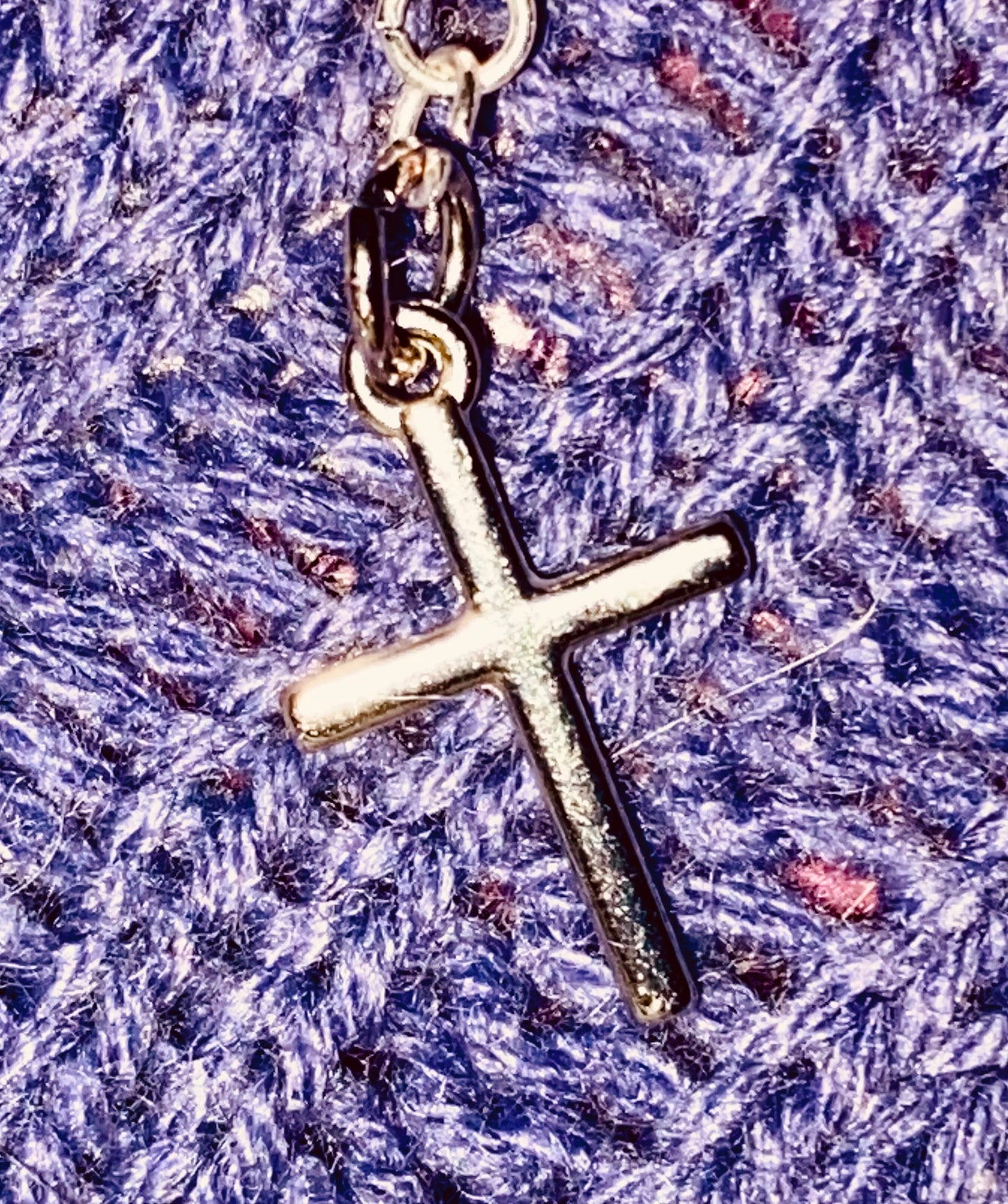 Simple Silver-toned Cross earrings hanging from linked chain.