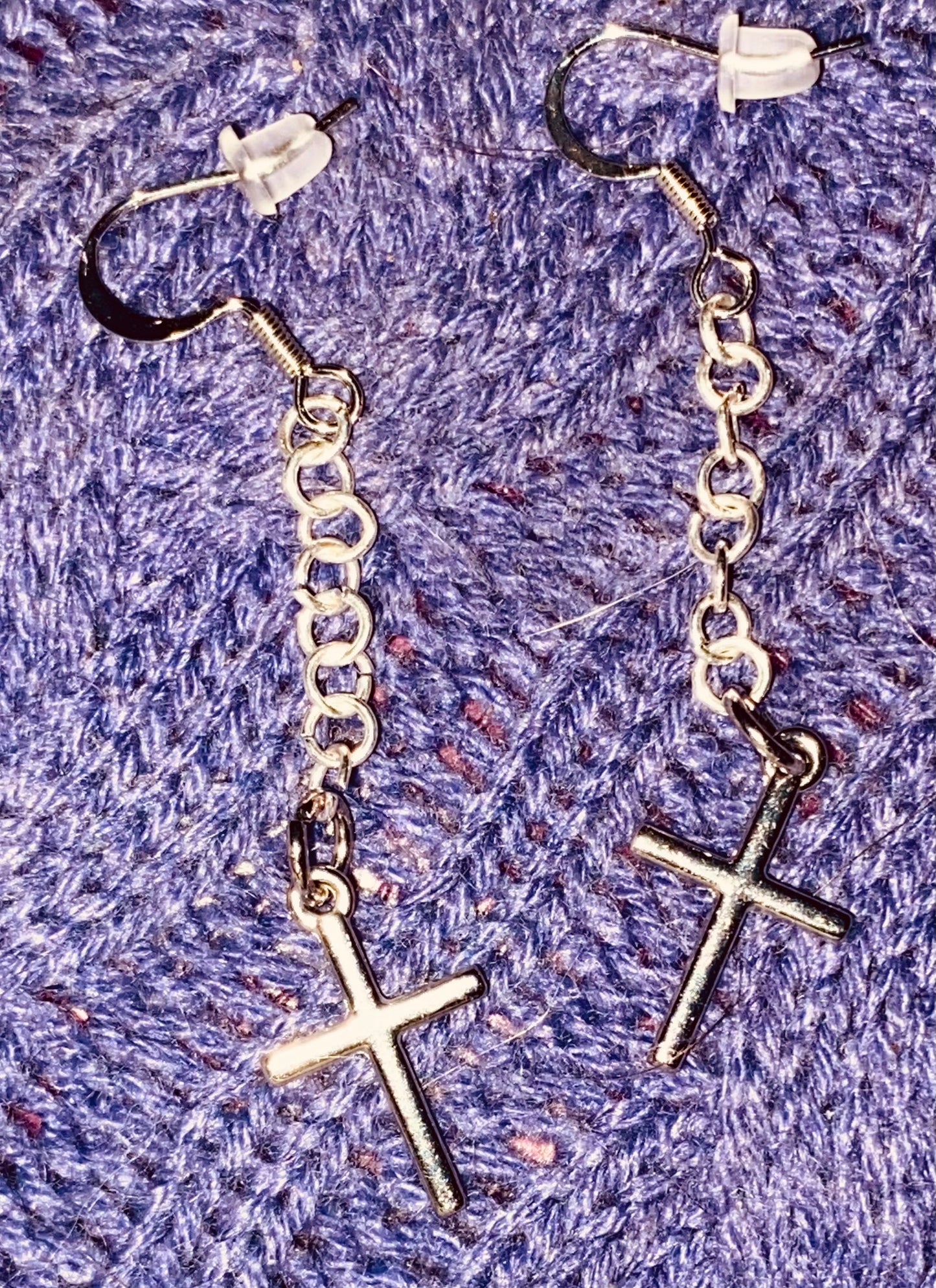 Simple Silver-toned Cross earrings hanging from linked chain.