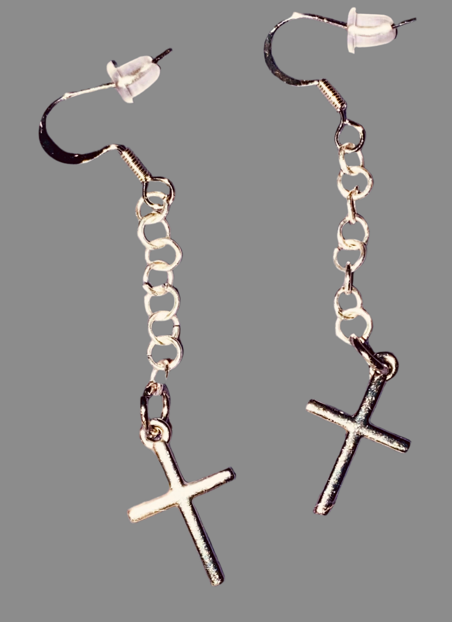 Simple Silver-toned Cross earrings hanging from linked chain.