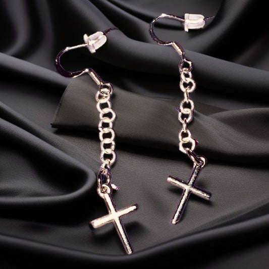 Simple Silver-toned Cross earrings hanging from linked chain.